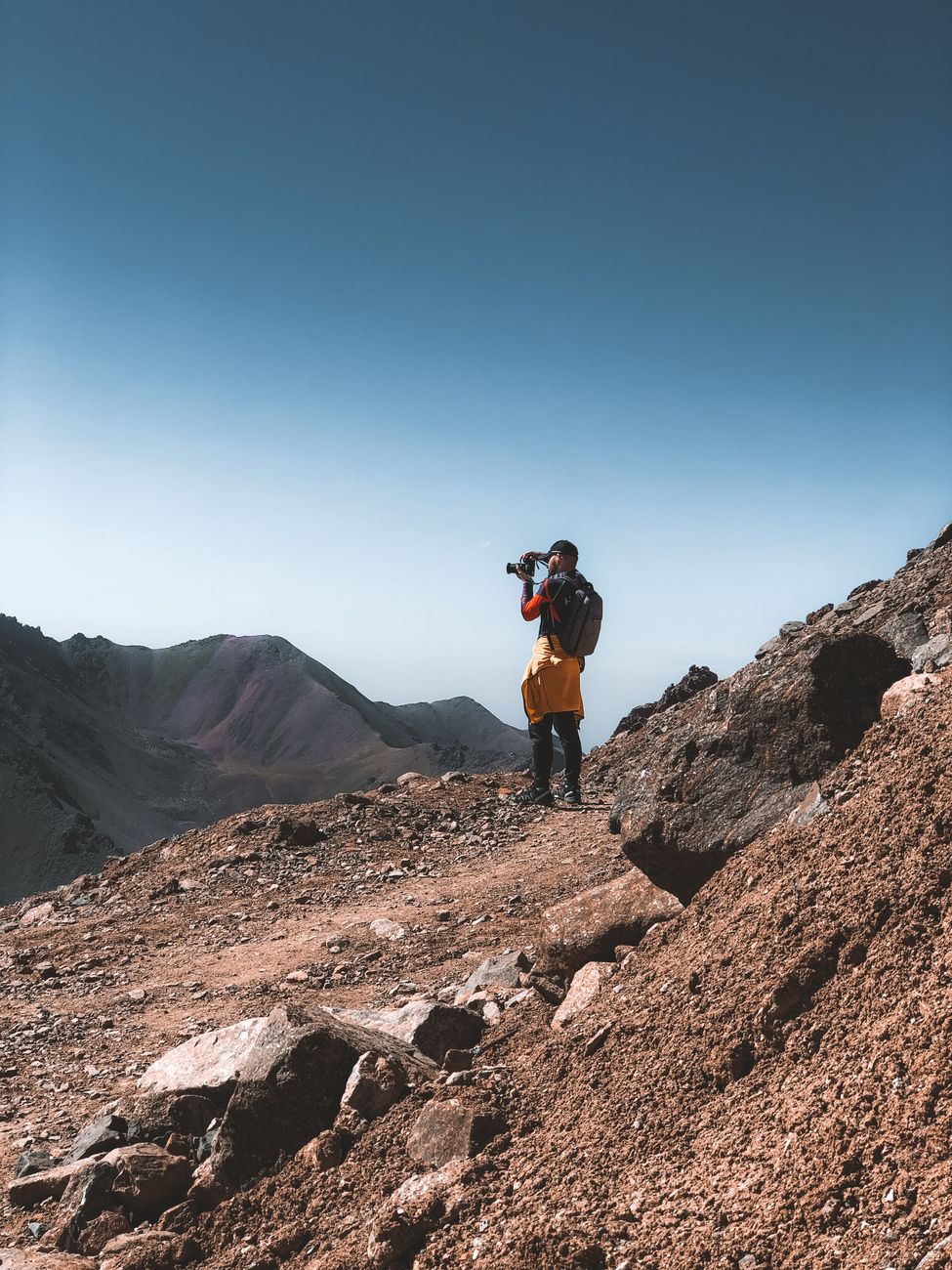 Travel photographer looking over mountain valley